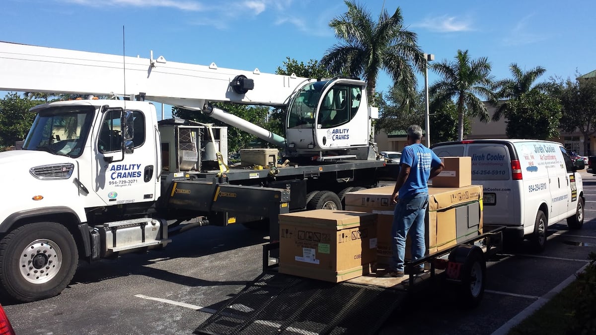 Crane truck delivering commercial HVAC equipment for a Jireh Cooler installation