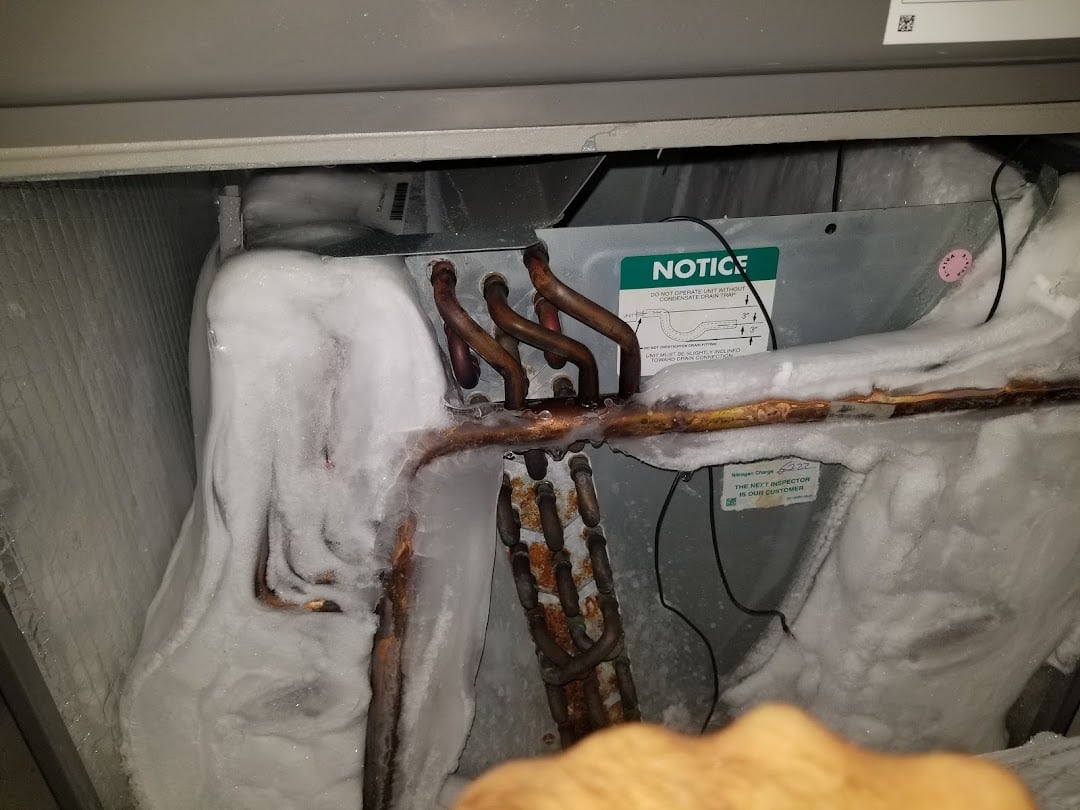 Frozen evaporator coil diagnosed by a Jireh Cooler technician during an urgent AC repair call