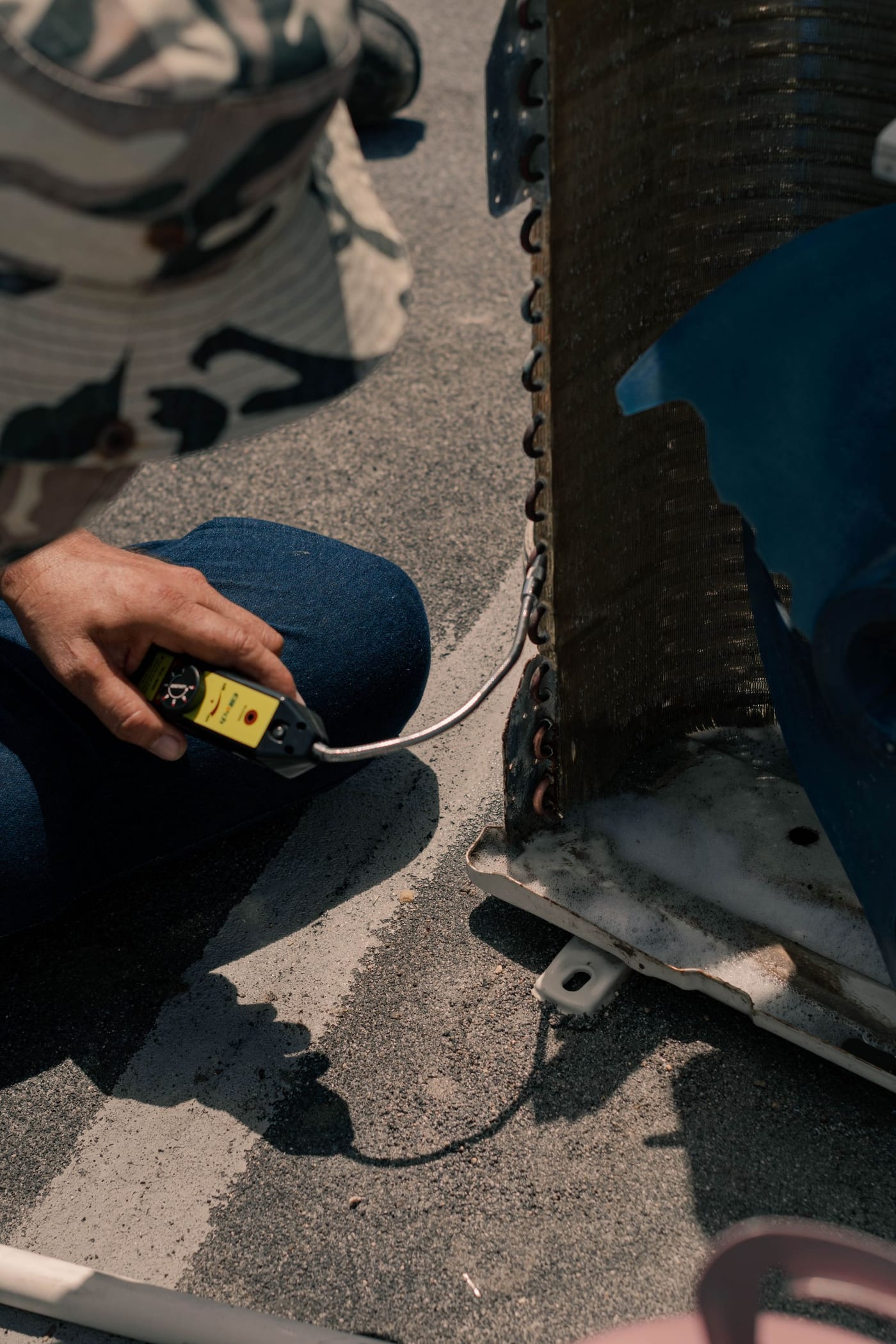 Technician working on a newly installed outdoor air conditioning unit